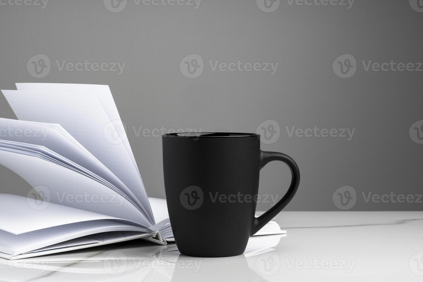 Ceramic mug on marble table on gray background photo
