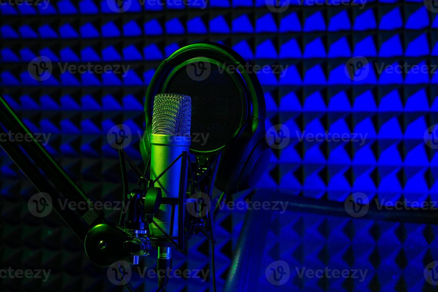 Professional microphone in a recording studio in blue light photo
