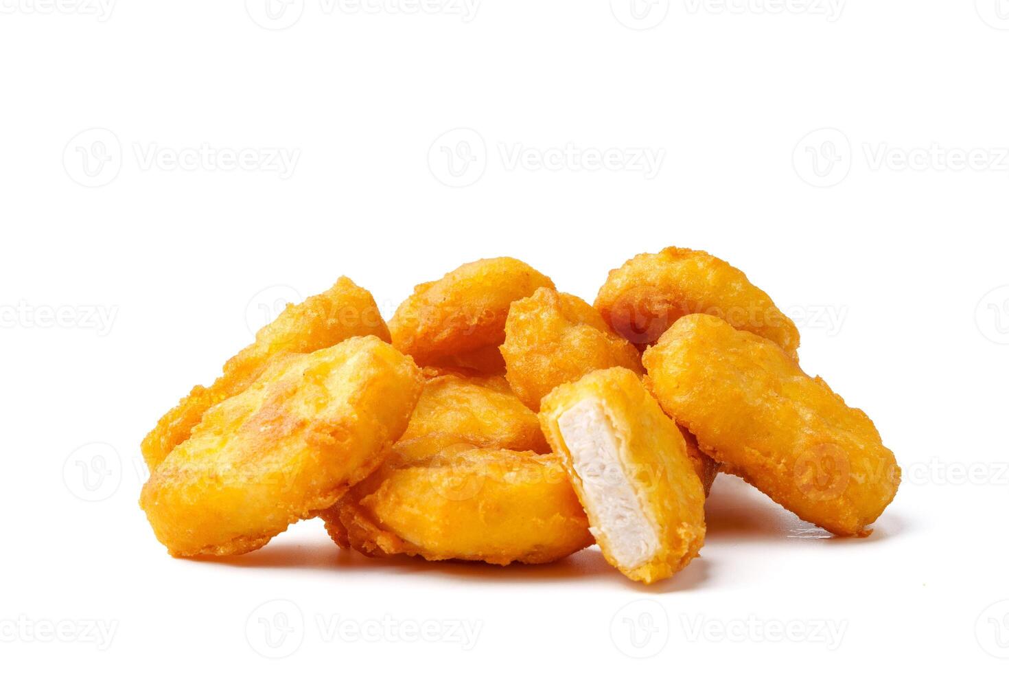 Pile of fried chicken nuggets isolated on white photo