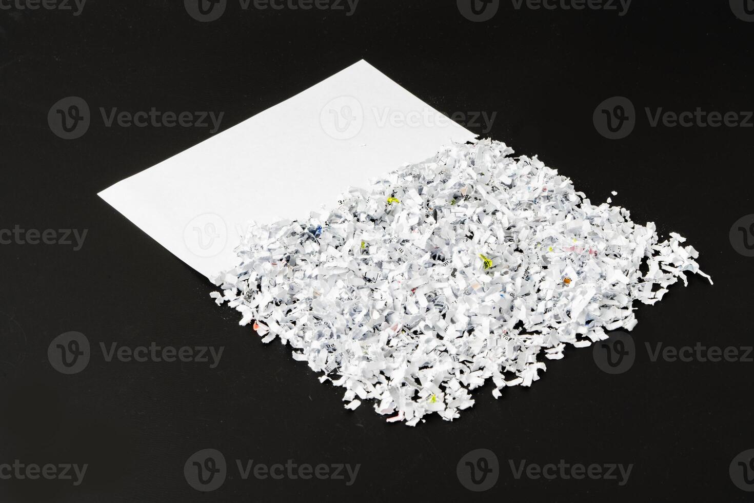 Shredded white paper on black background close up photo