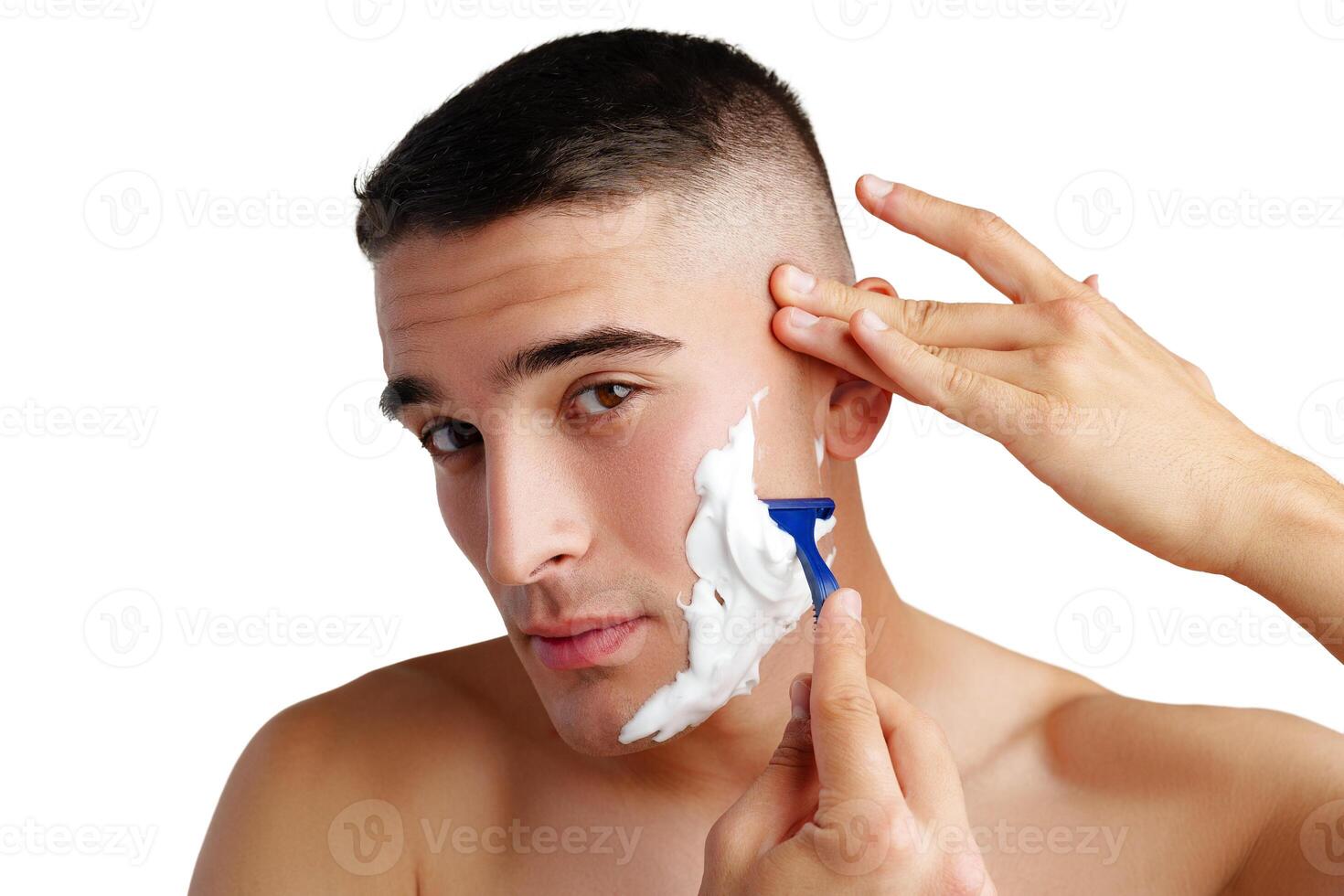 Young handsome man applying shaving foam against white background photo