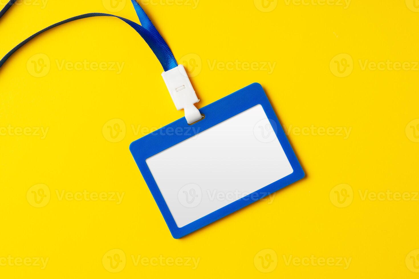 Blank nametag on a string on yellow background copy space photo