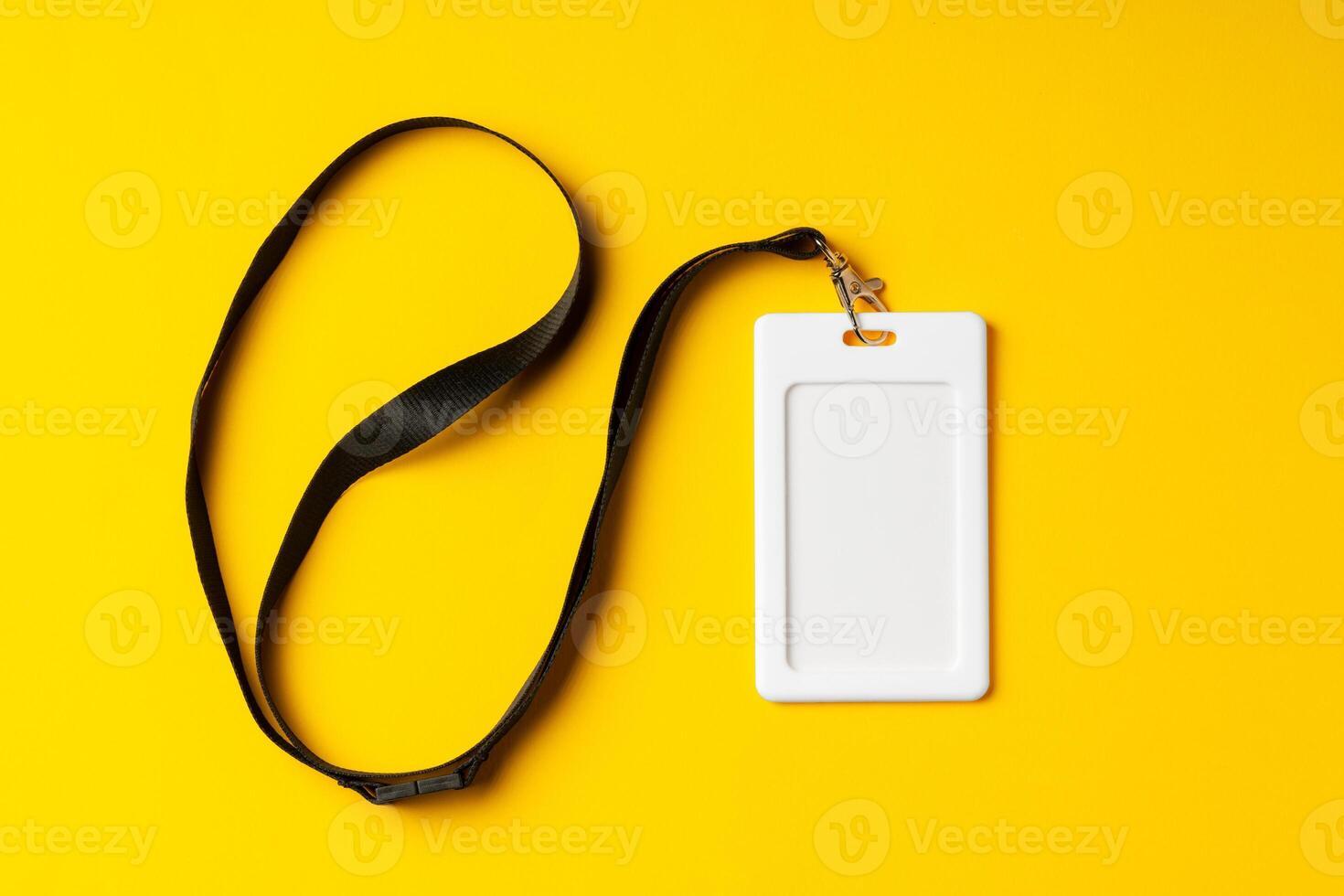 Blank nametag on a string on yellow background copy space photo