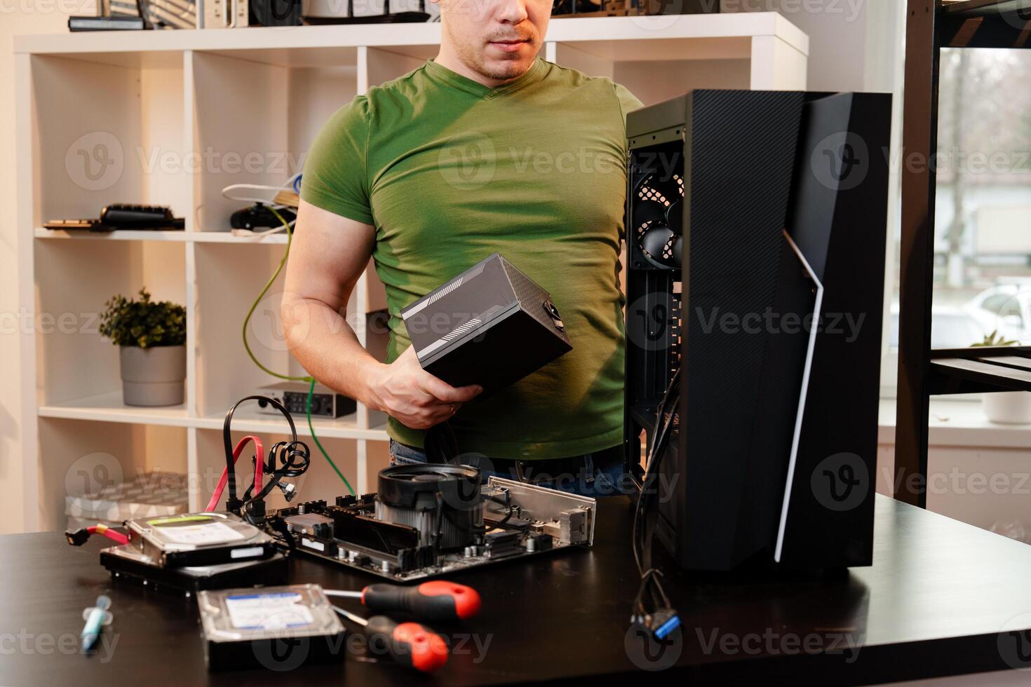Man assembles a computer system unit at home photo
