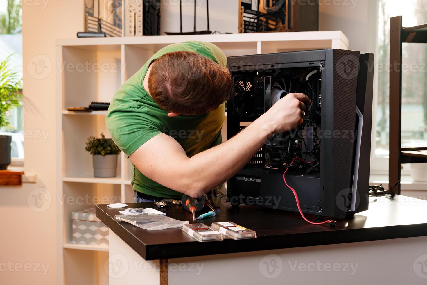 Man assembles a computer system unit at home photo