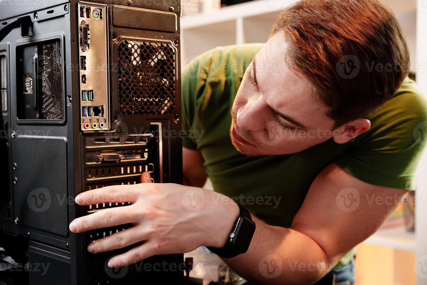 Man assembles a computer system unit at home photo