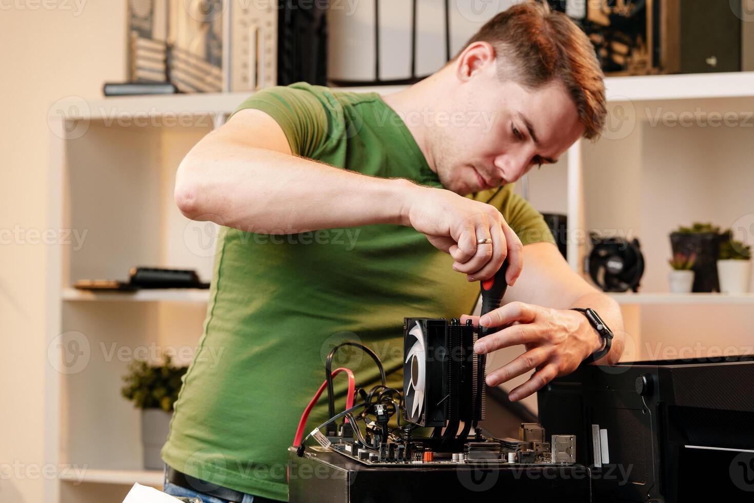 Man assembles a computer system unit at home photo