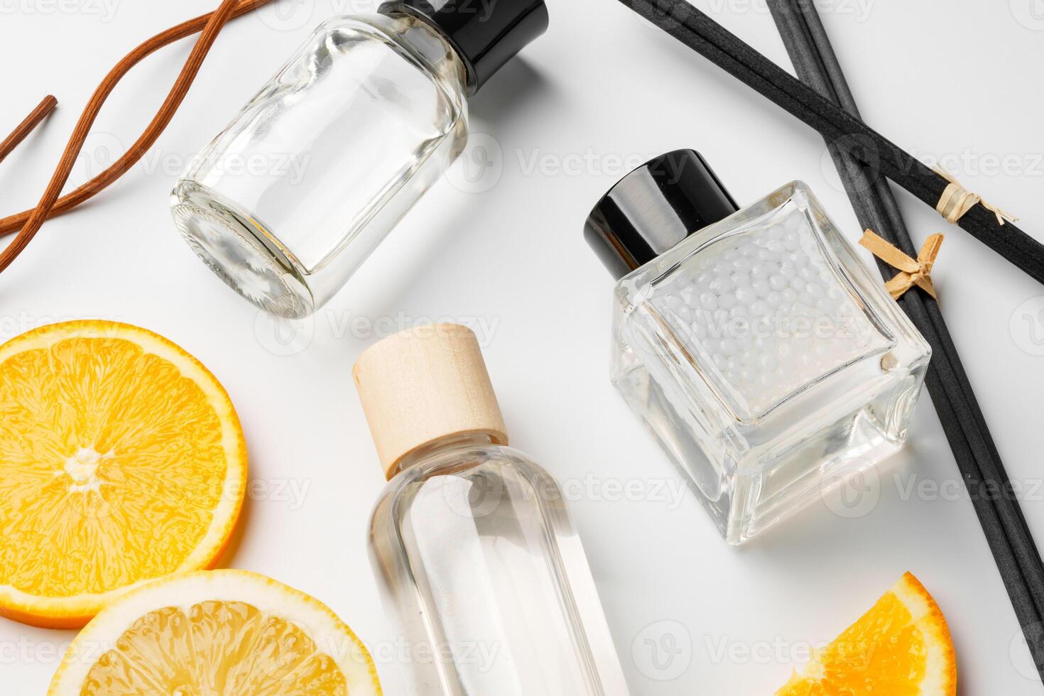 Aromatic display of essential oils with citrus fruit and chopsticks on a minimalist background photo