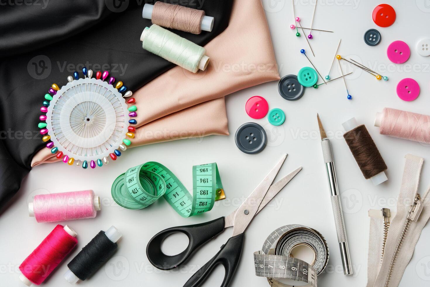 Crafting essentials for sewing projects displayed on a table with fabric, threads, and tools photo