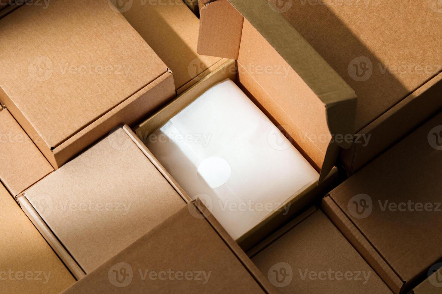Stacked cardboard boxes arranged in a neat pattern under natural light photo