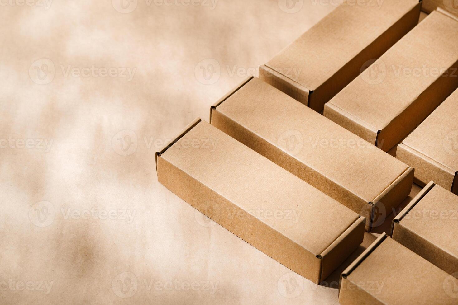 Brown cardboard boxes arranged on a neutral background in a warehouse setting during daylight hours photo