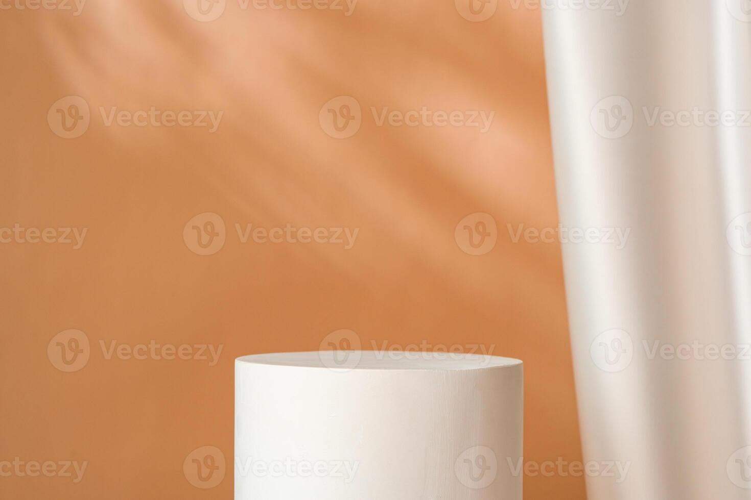 Minimalist decor featuring a white cylinder and draped fabric in a warm-toned interior with soft lighting photo