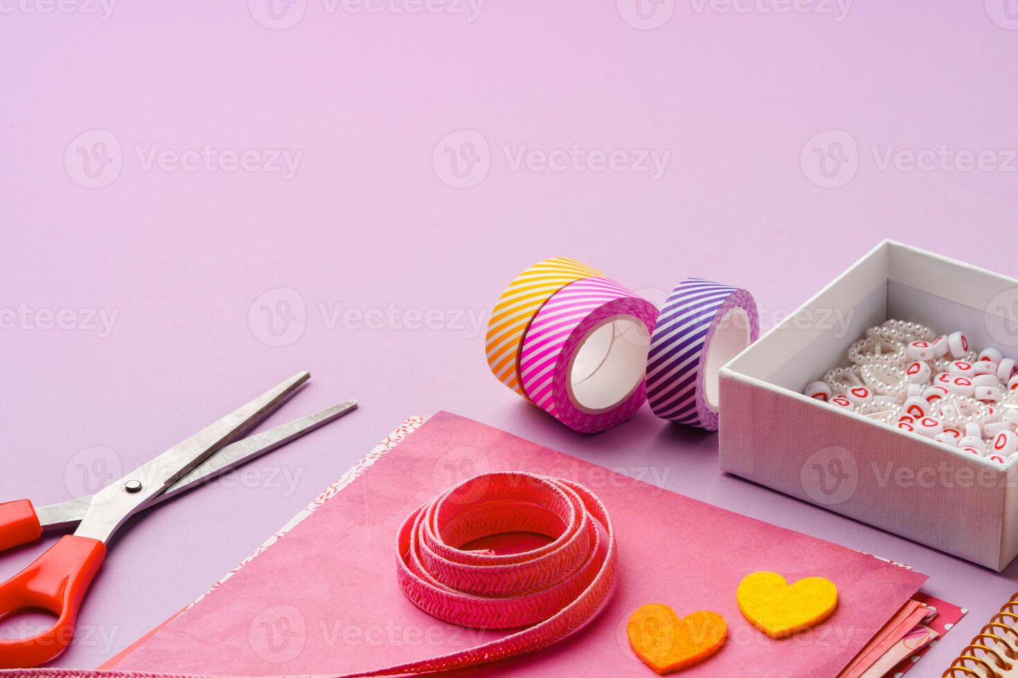Crafting supplies on a purple background ready for creative projects photo