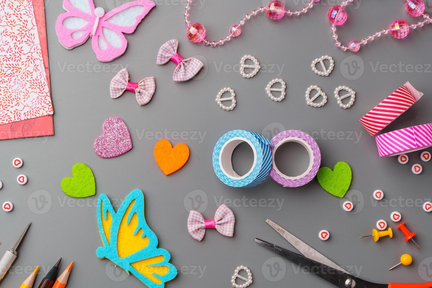 Crafting materials and tools arranged on a gray surface during a creative project photo