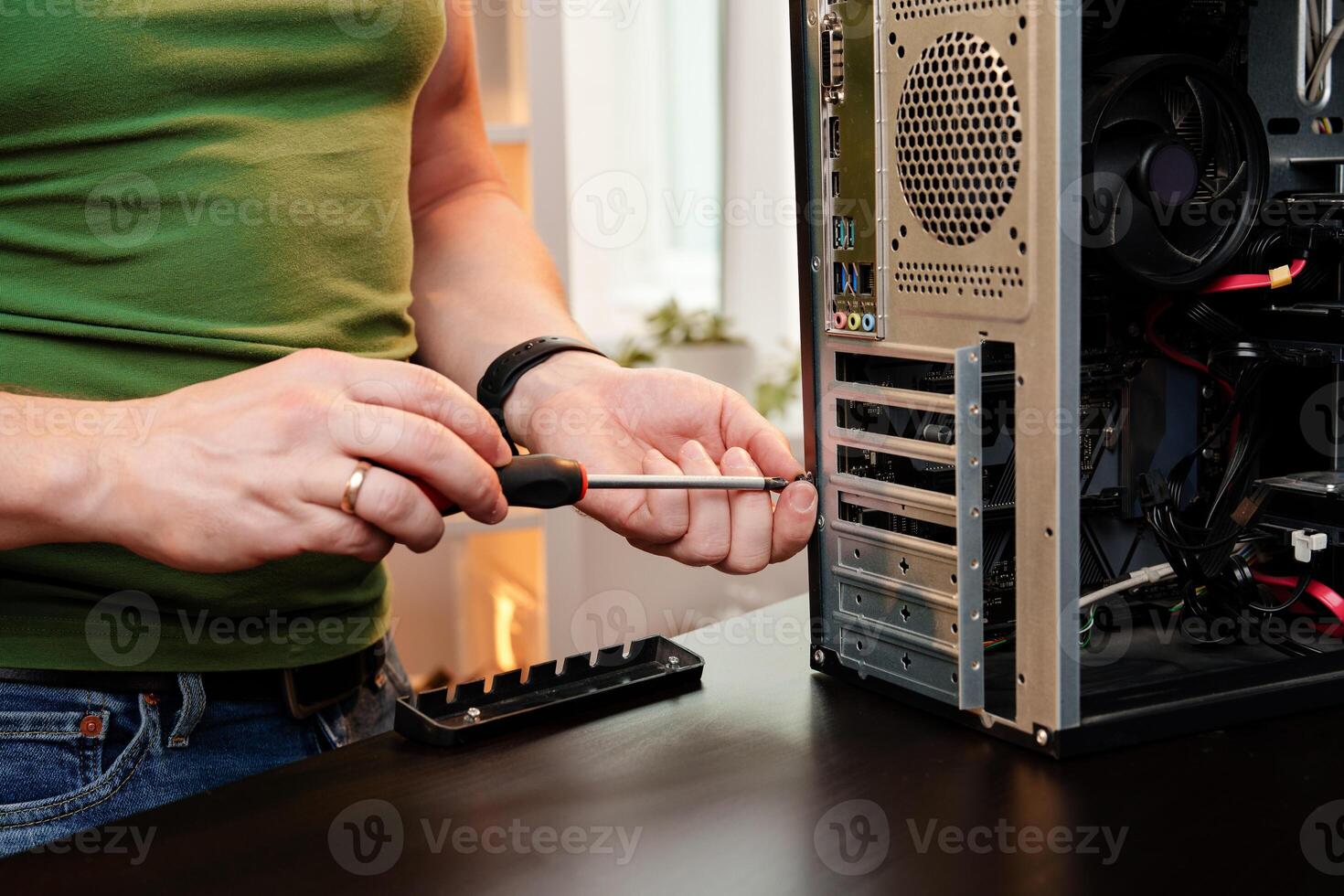 Close up of man repairing computer system unit photo