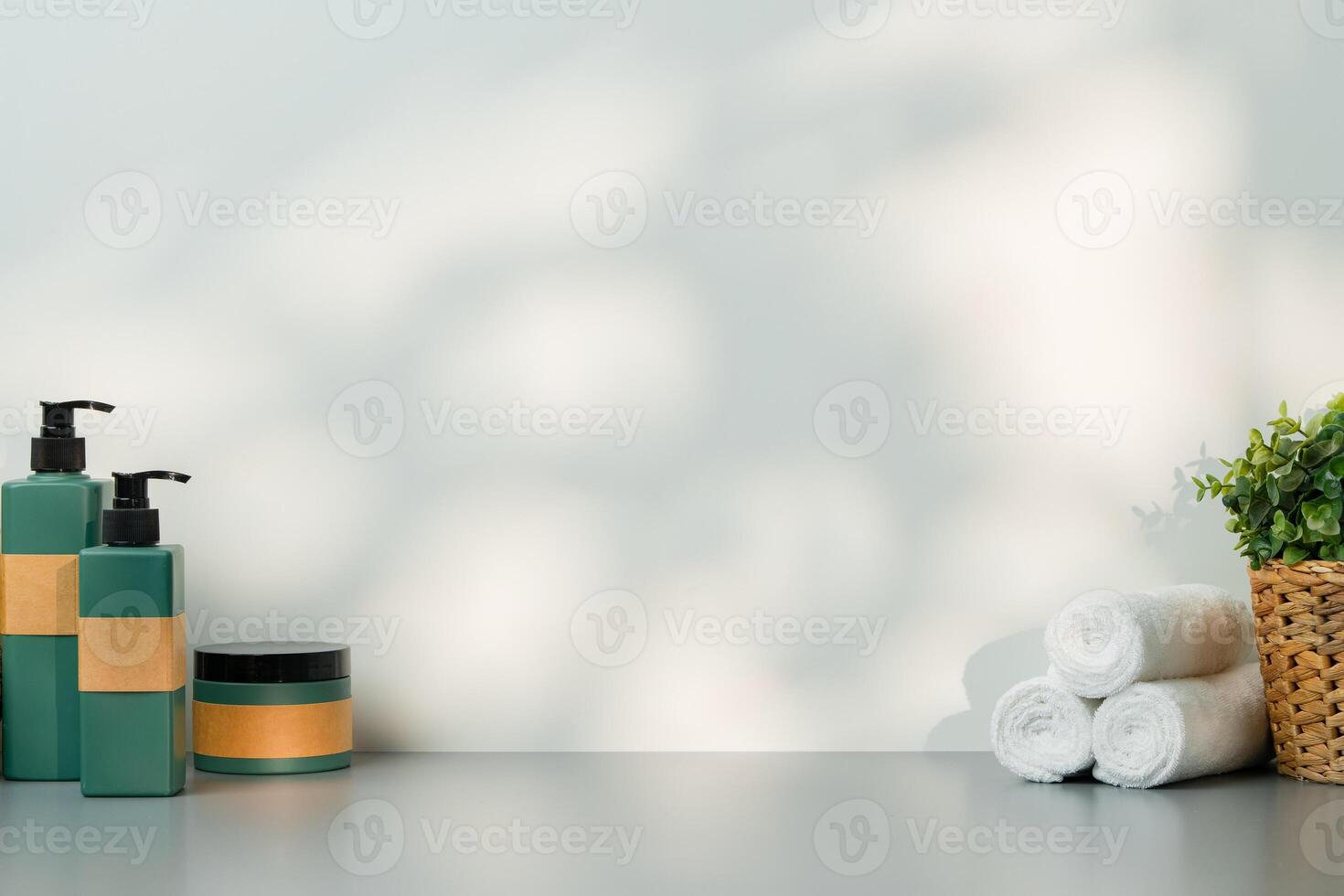 Soap dispenser and spa towels on white background in shadow photo