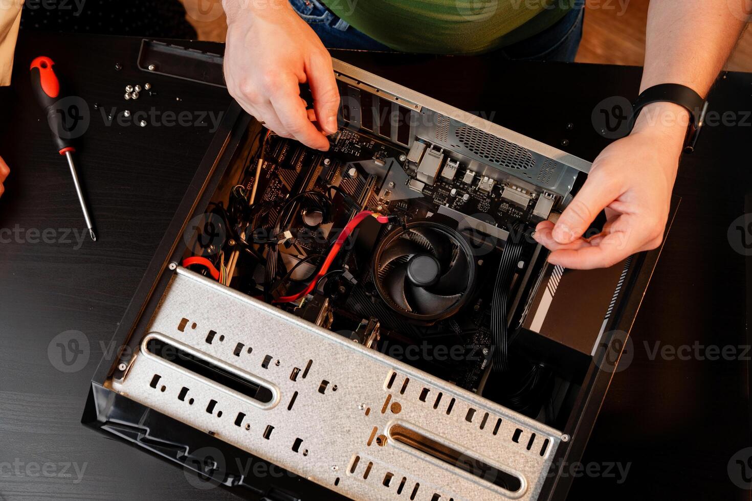 Close up of man repairing computer system unit photo