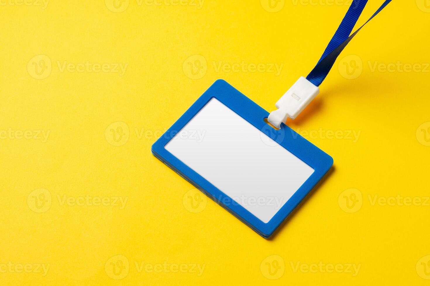 Blank nametag on a string on yellow background copy space photo