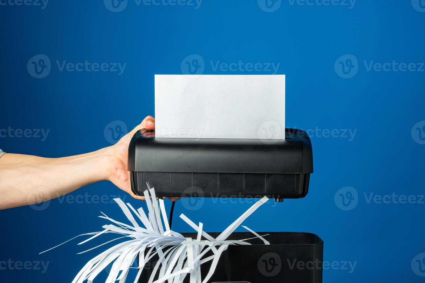 Shredded paper pieces on a blue background photo