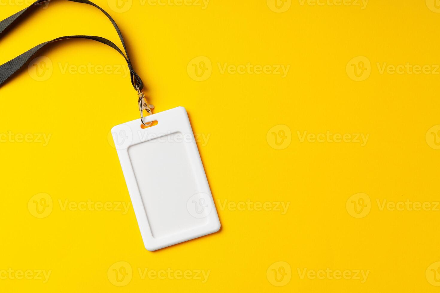 Blank nametag on a string on yellow background copy space photo