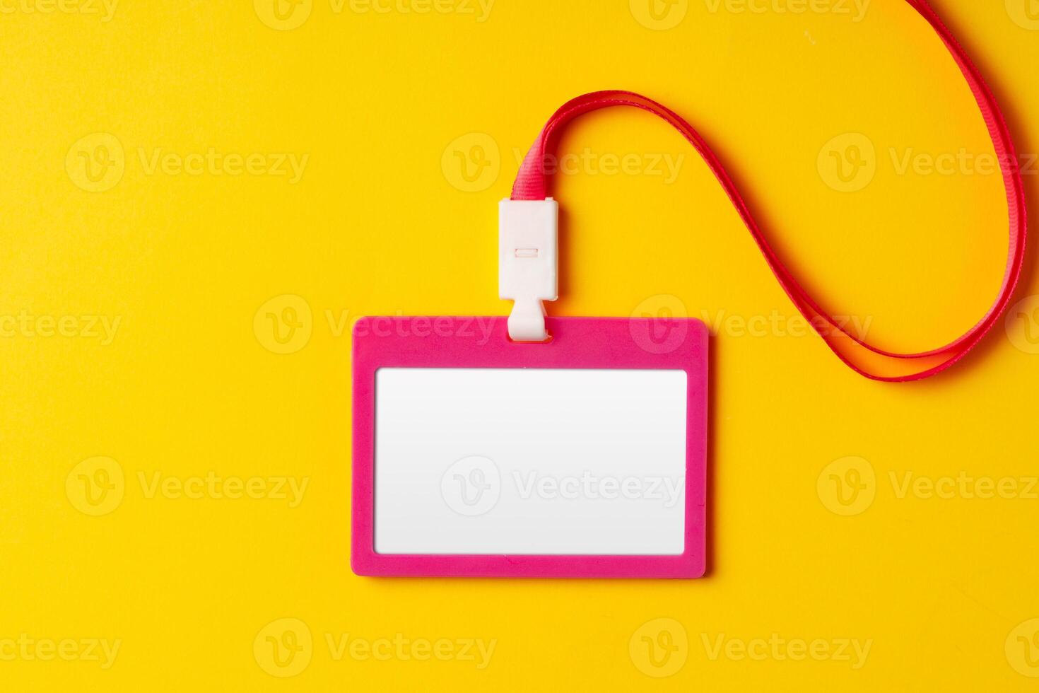 Blank nametag on a string on yellow background copy space photo