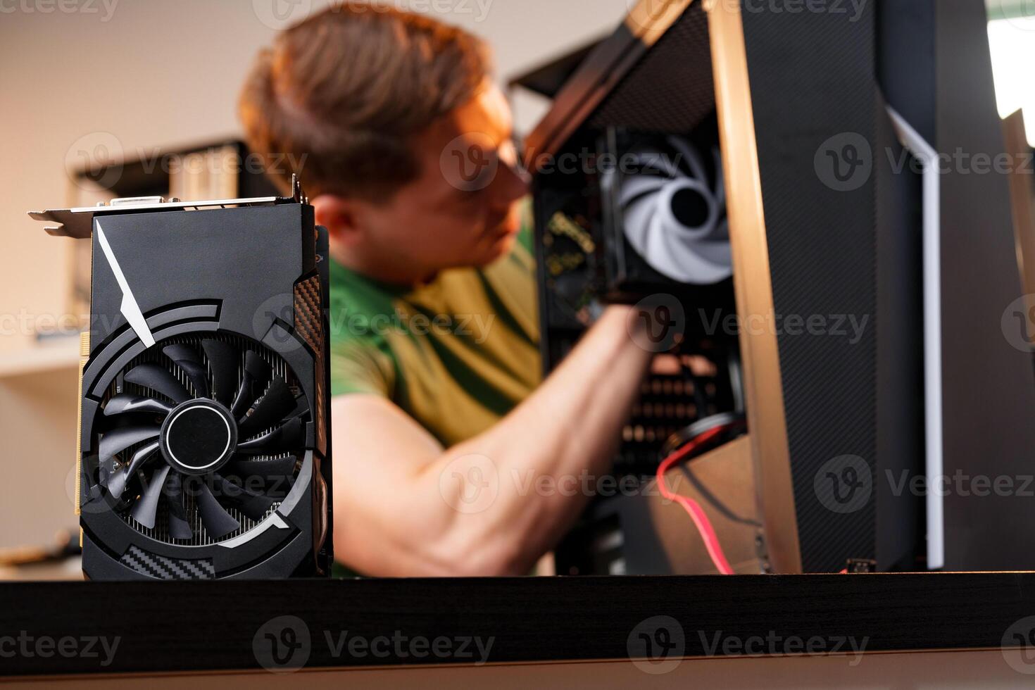 Man assembles a computer system unit at home photo
