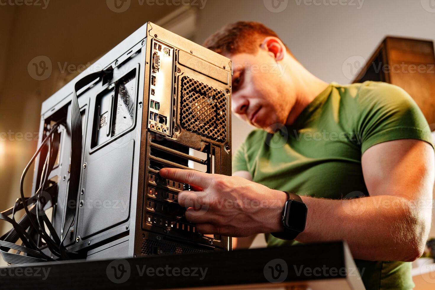 Man assembles a computer system unit at home photo
