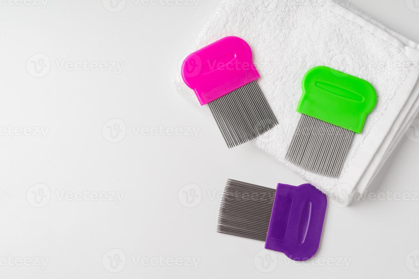 Anti lice combs and towel on white background photo