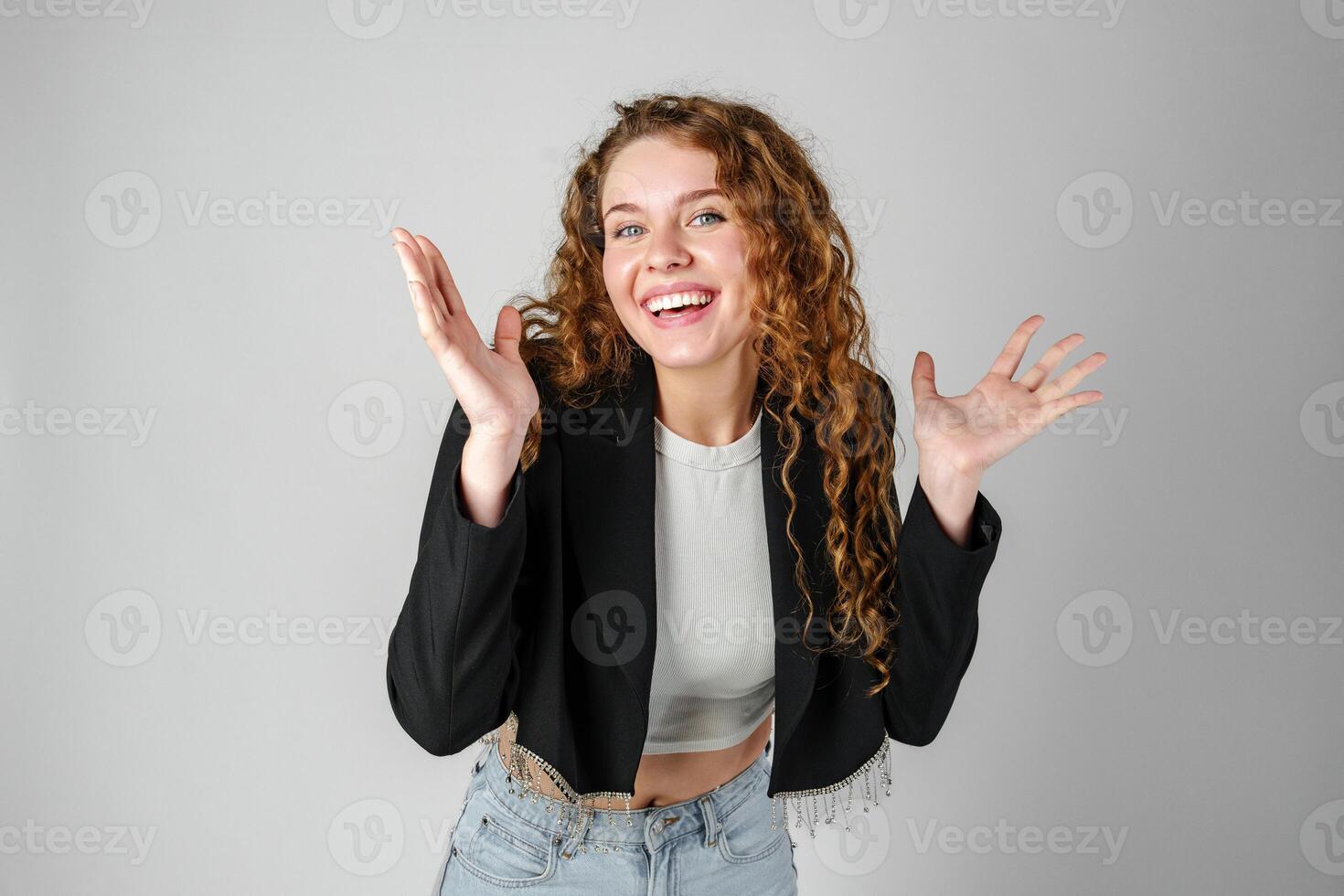 Young Curly Clueless Woman Holding Out Hands photo
