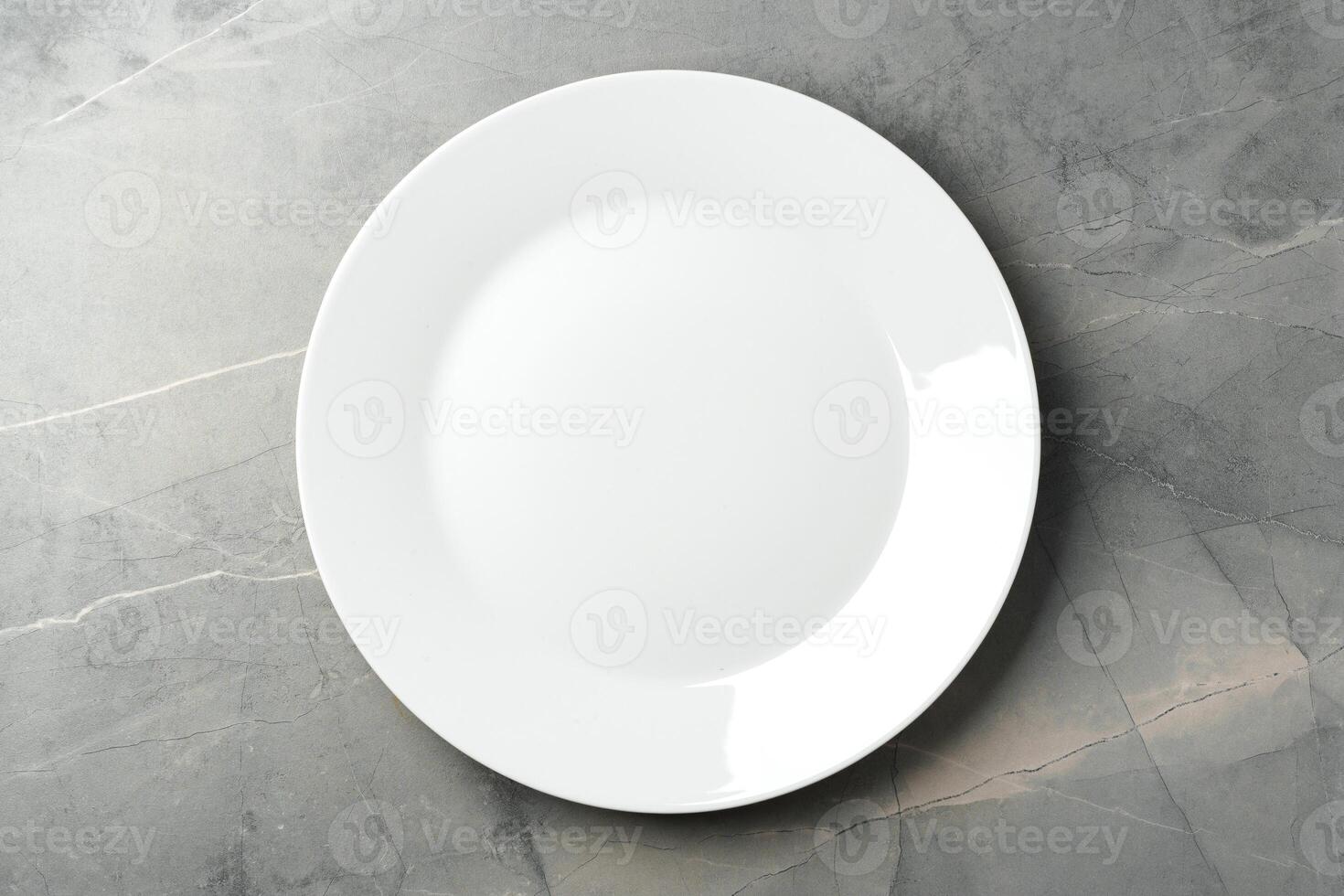 White empty plate on gray background top view photo