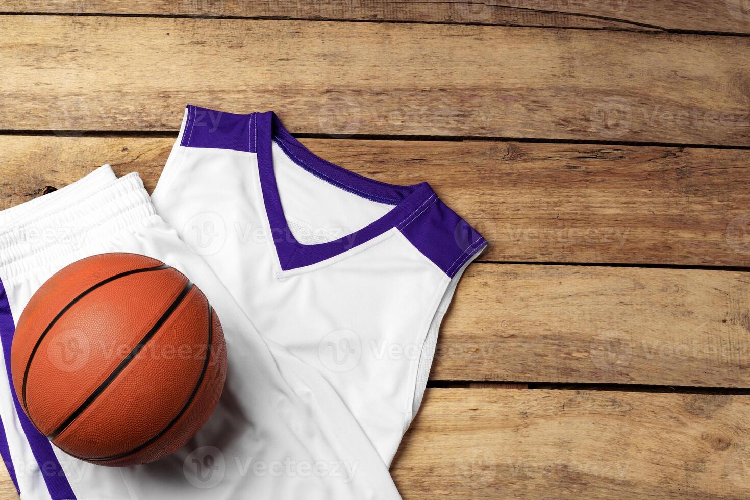 Basketball uniform on wooden background top view photo