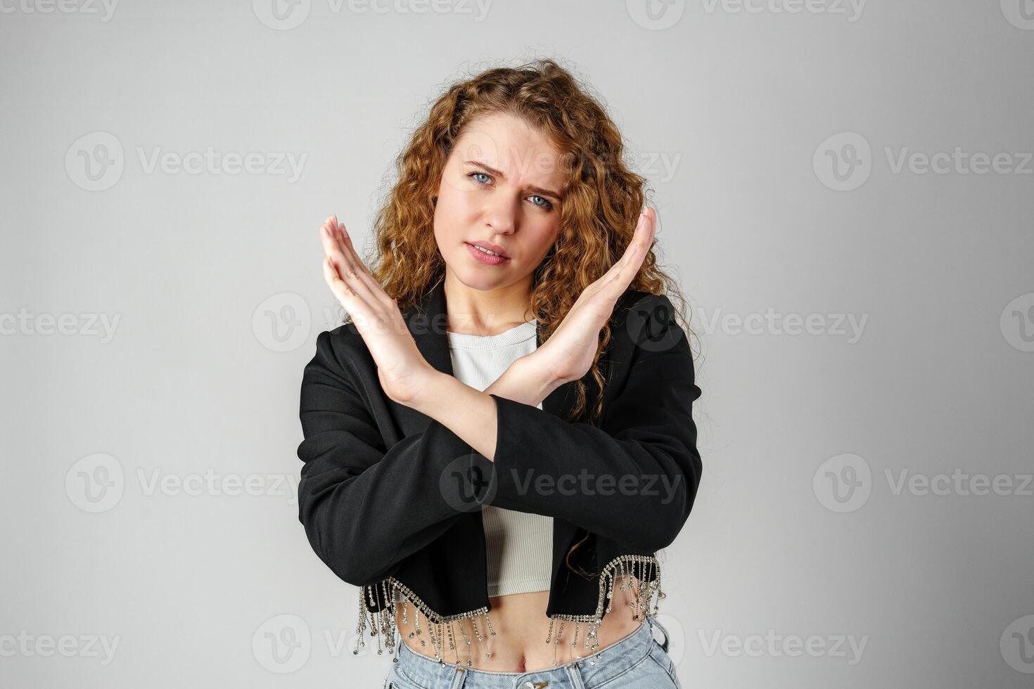 Young Woman Standing With Her Arms Crossed photo