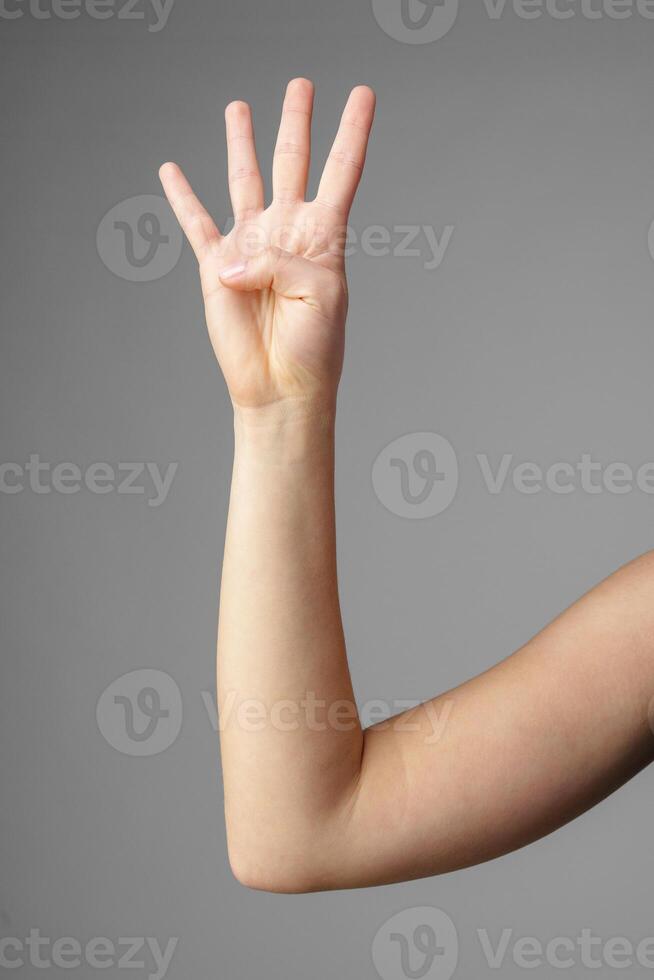 Woman Holding Arm Up in the Air with Gesture photo