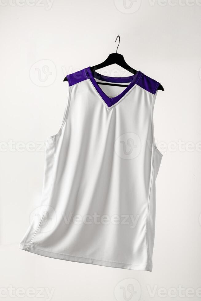 White basketball jersey hanging against white background photo