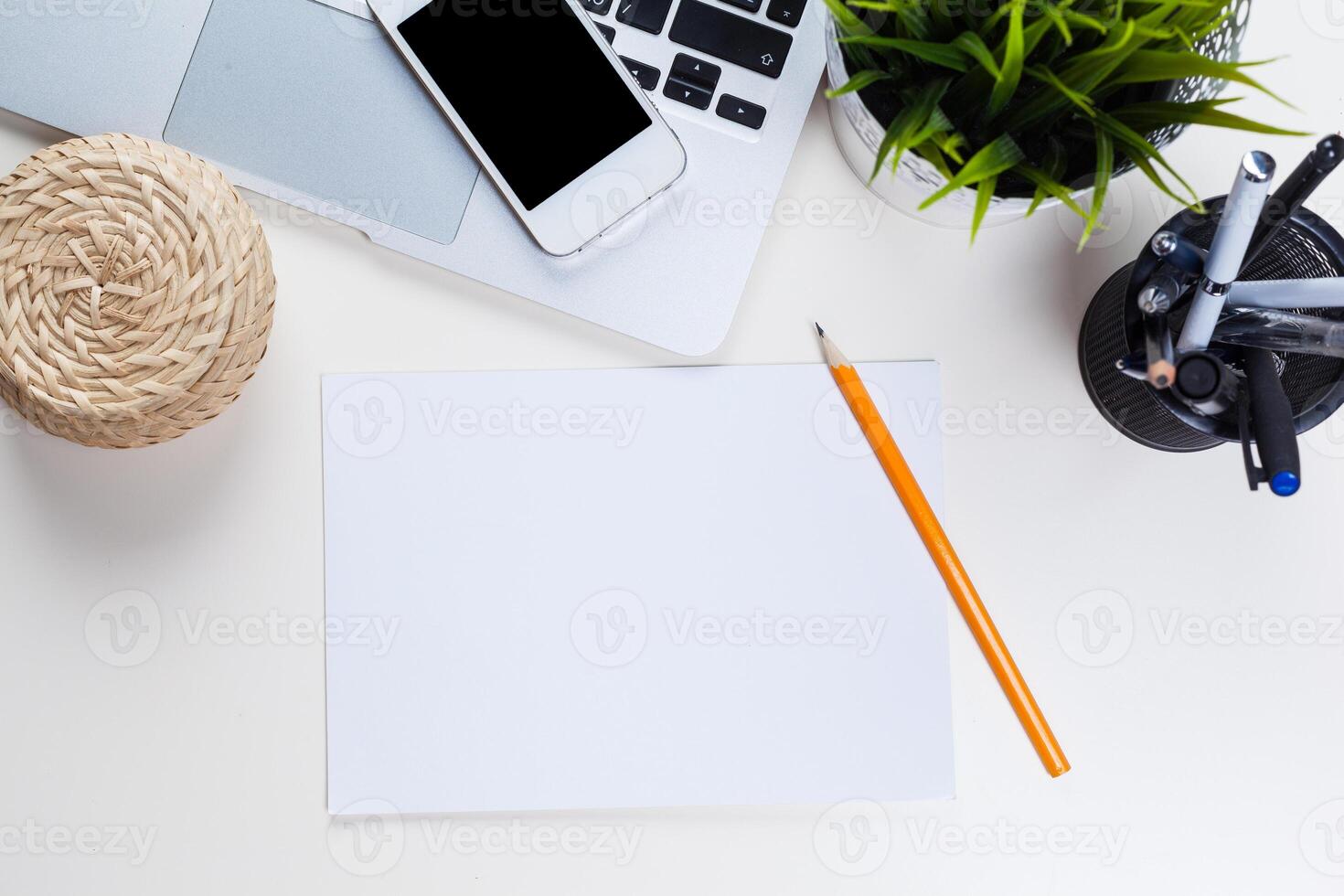 White office desk table with a lot of things on it. Top view photo