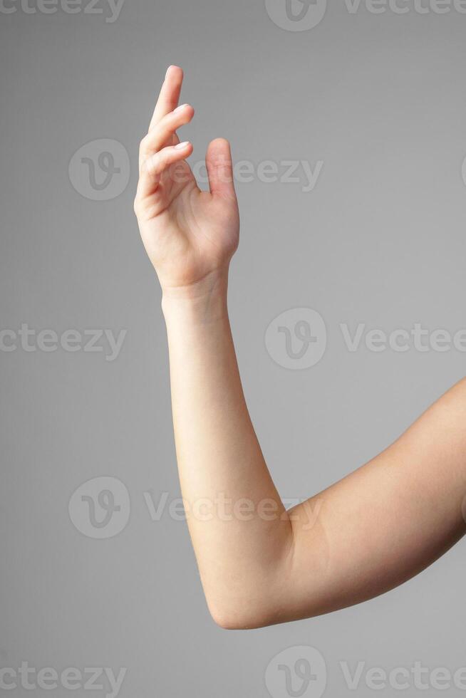 Woman Holding Arm Up in the Air with Gesture photo