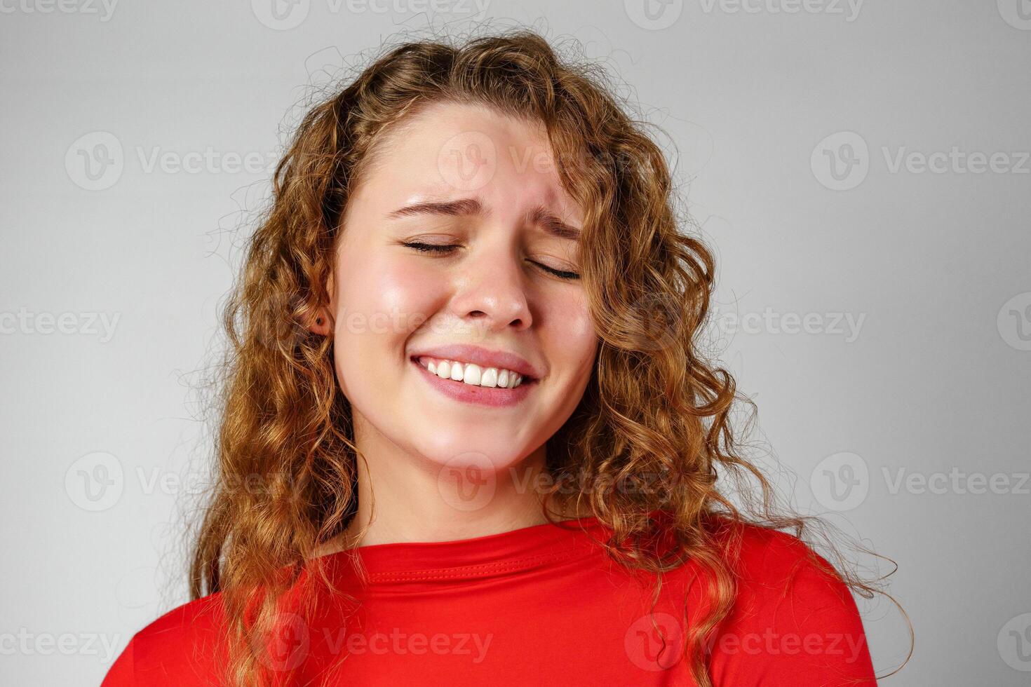 Young Woman With Curly Hair Expressing Concern photo
