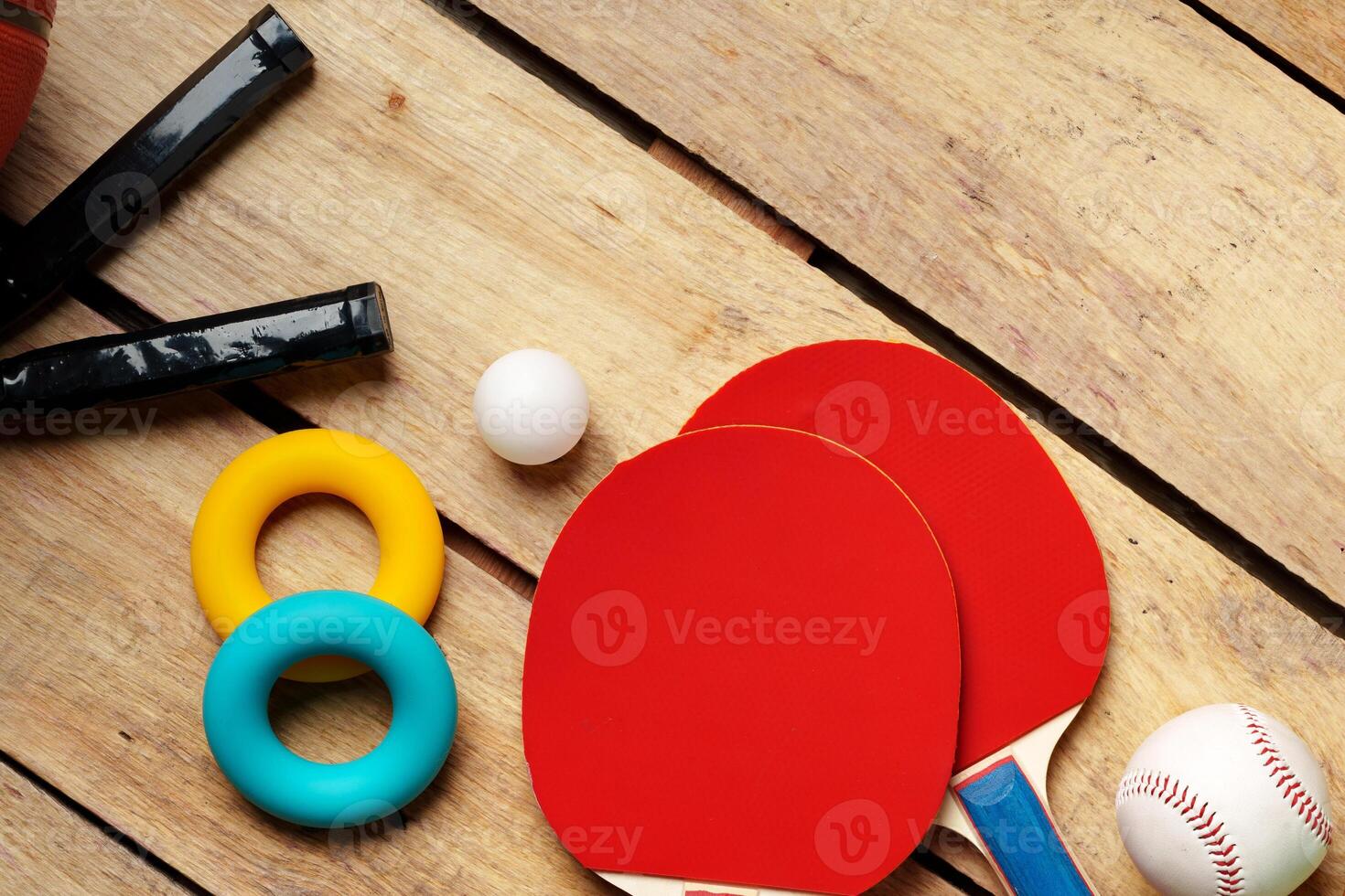 Different sports equipment on wooden background top view photo