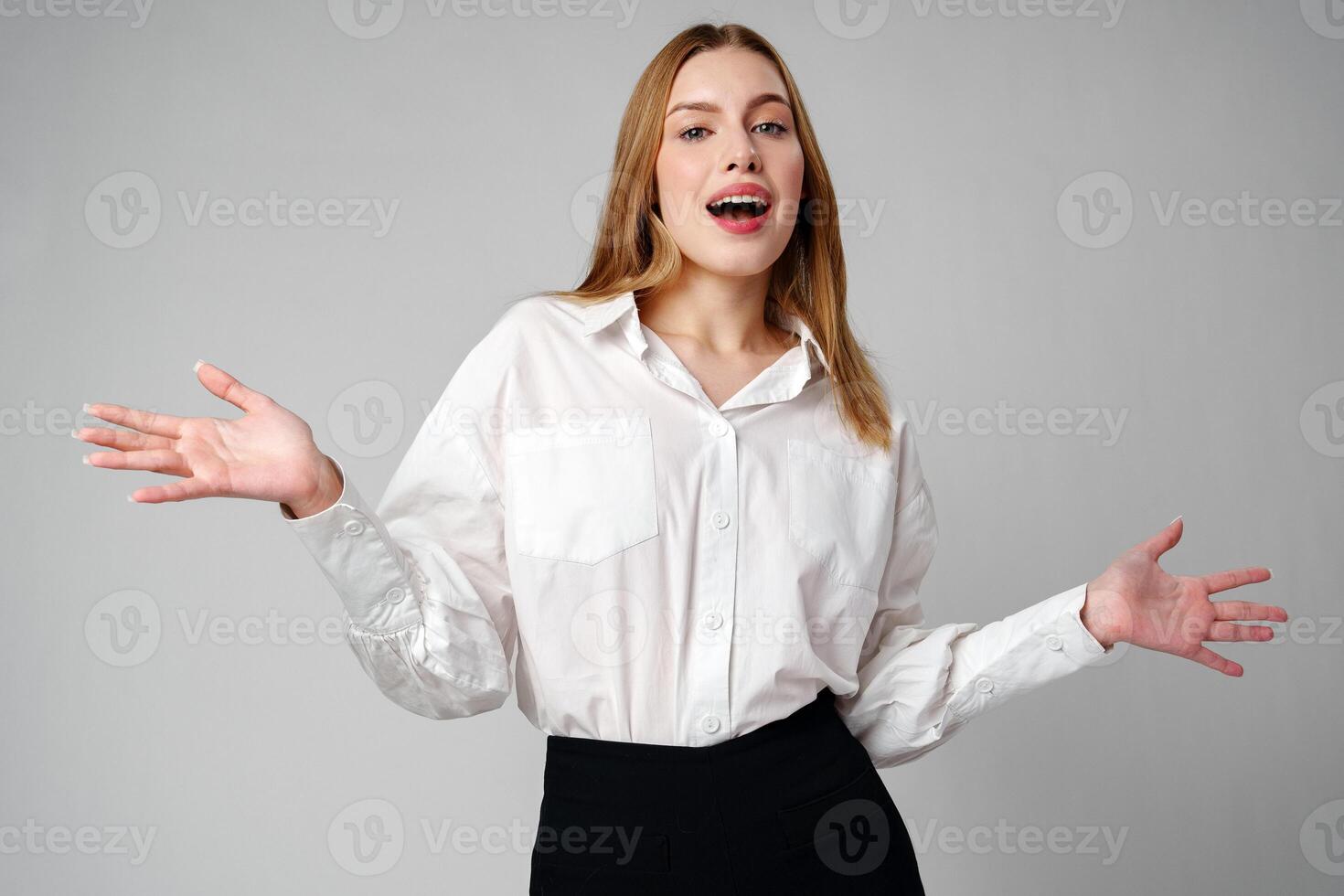 Joyful Young Blonde Woman Smiling against gray background photo