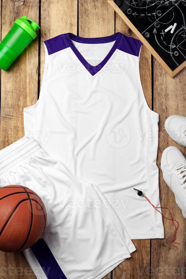 Basketball uniform on wooden background top view photo