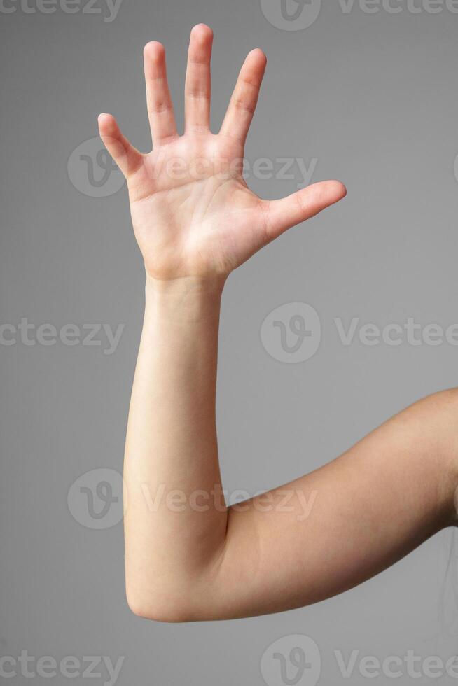 Woman Holding Arm Up in the Air with Gesture photo