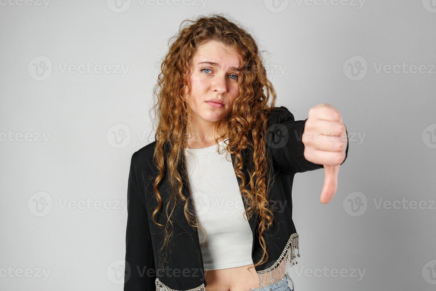 Woman With Curly Hair Giving a Thumbs Down photo