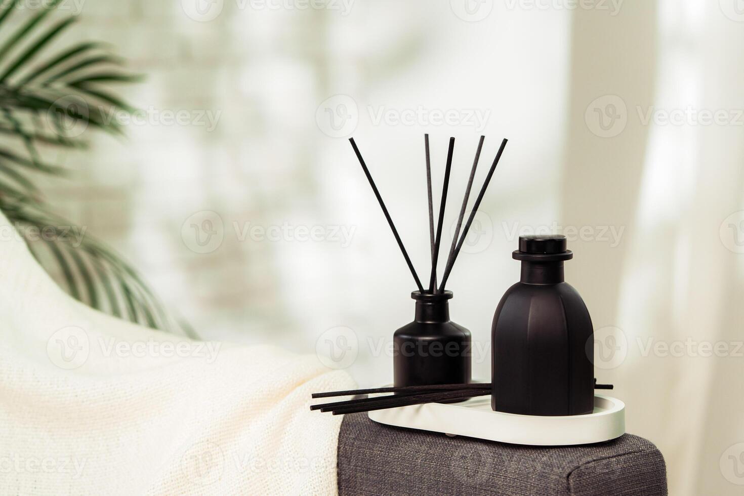 Aroma diffuser bottle with sticks in living room photo