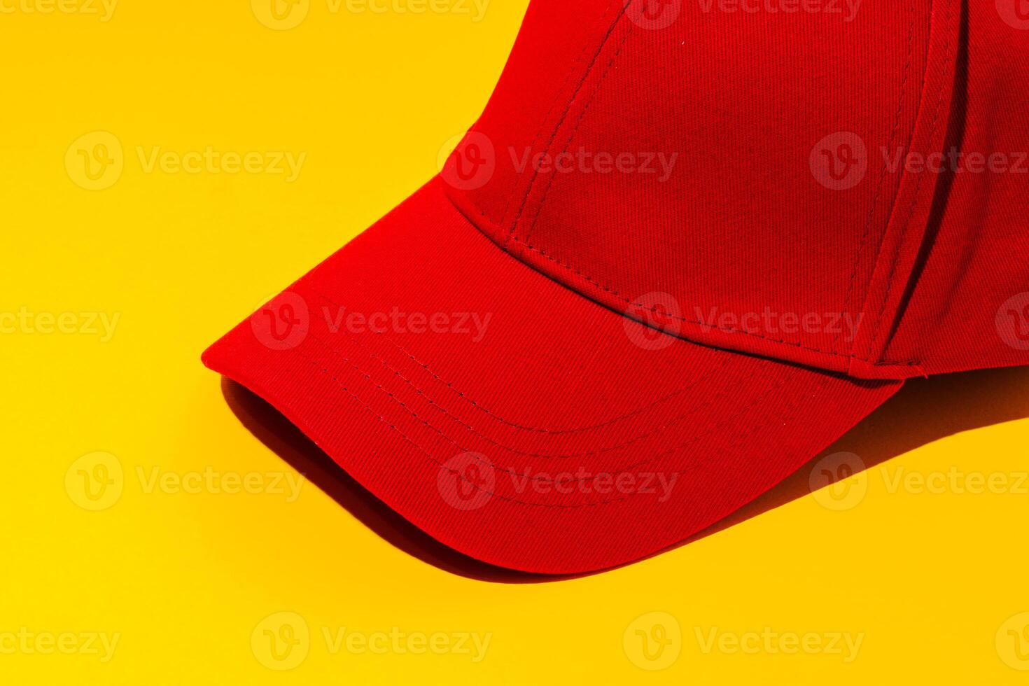 Baseball hat against yellow background in studio photo
