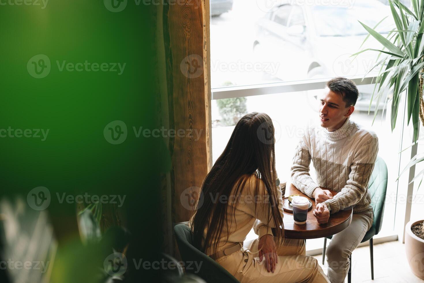 Man and Woman Sitting at Table Talking photo
