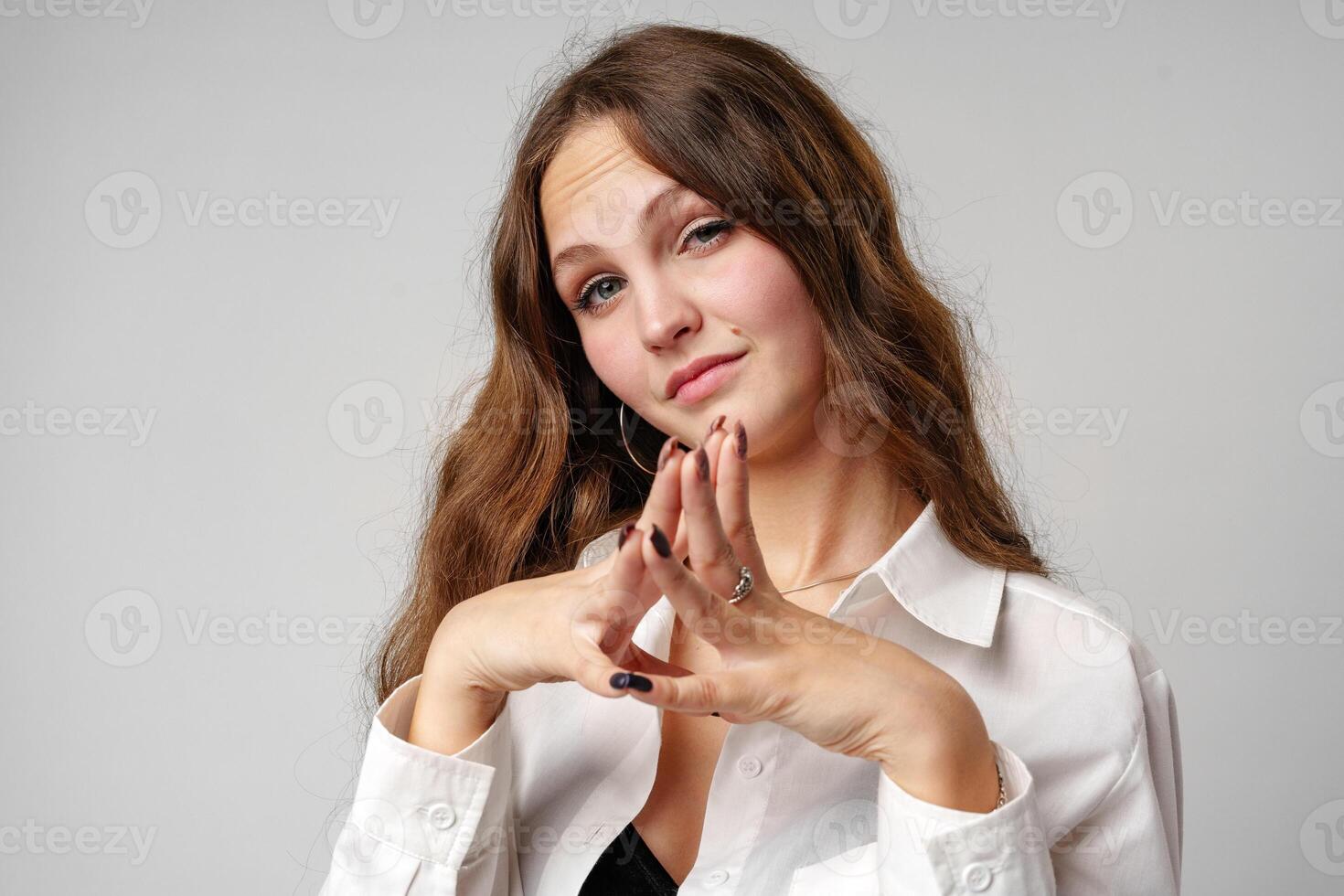 Woman in White Shirt Making Hand Gesture photo