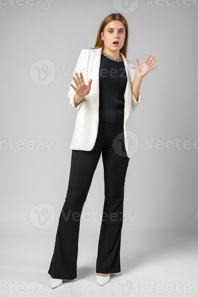 Excited Young Woman in Stylish Outfit Surprised Expression photo