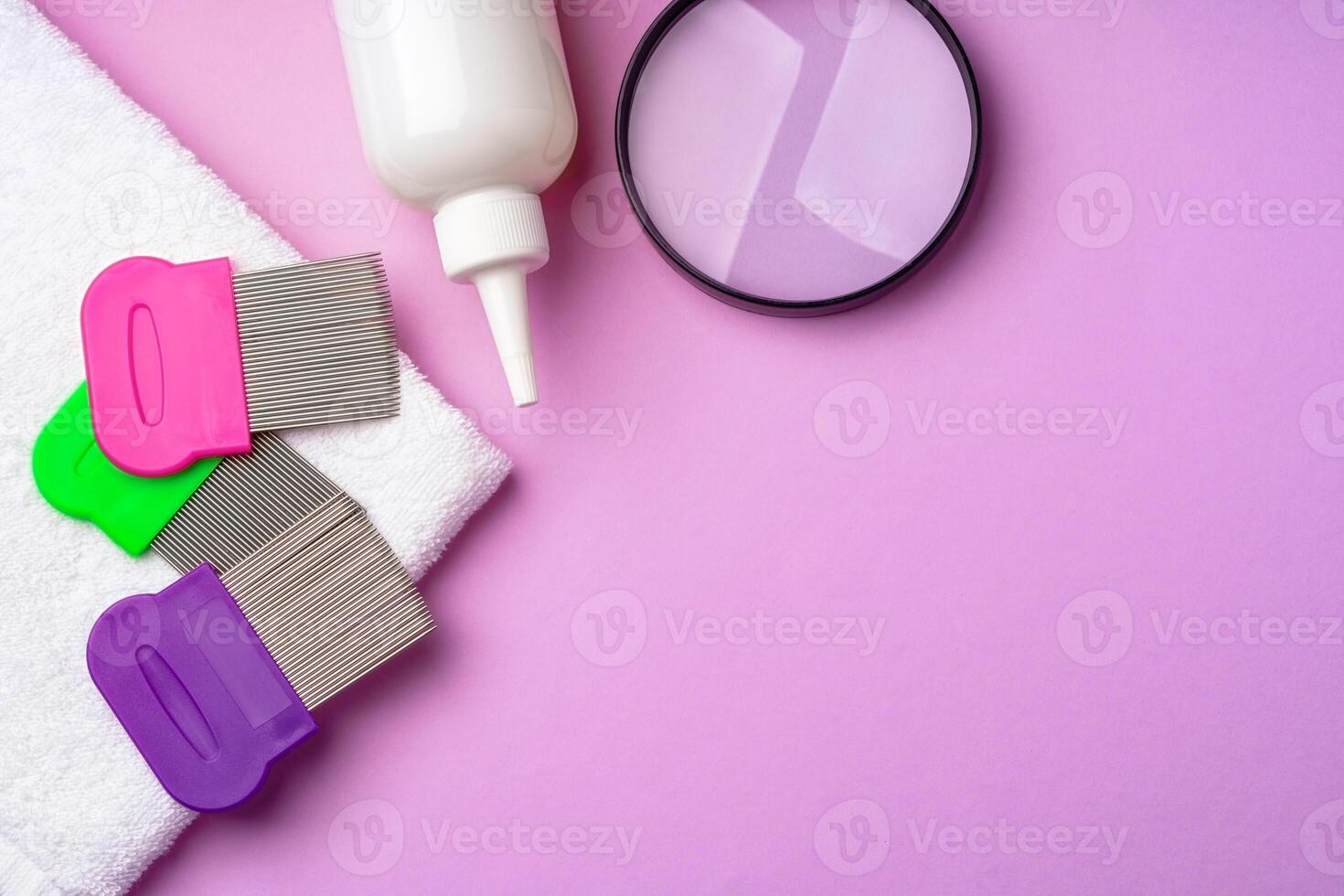 Anti lice combs and towel on pink background photo