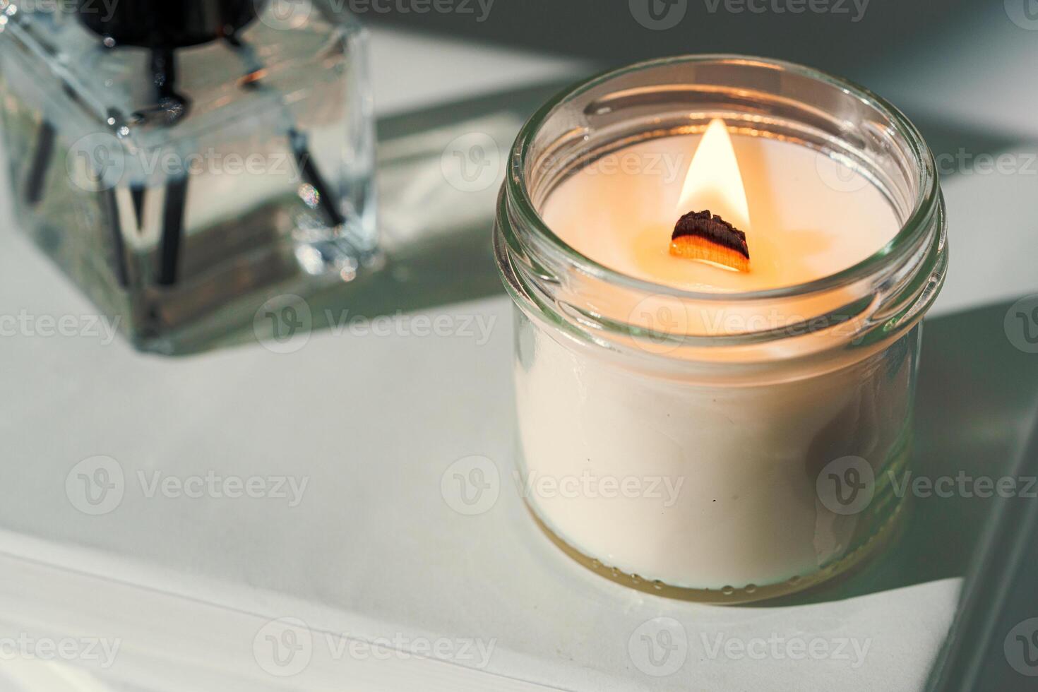 Aromatic candle in glass jar close up photo