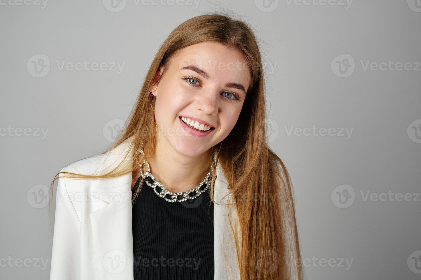 Woman in Black Top and White Jacket Posing in Studio photo